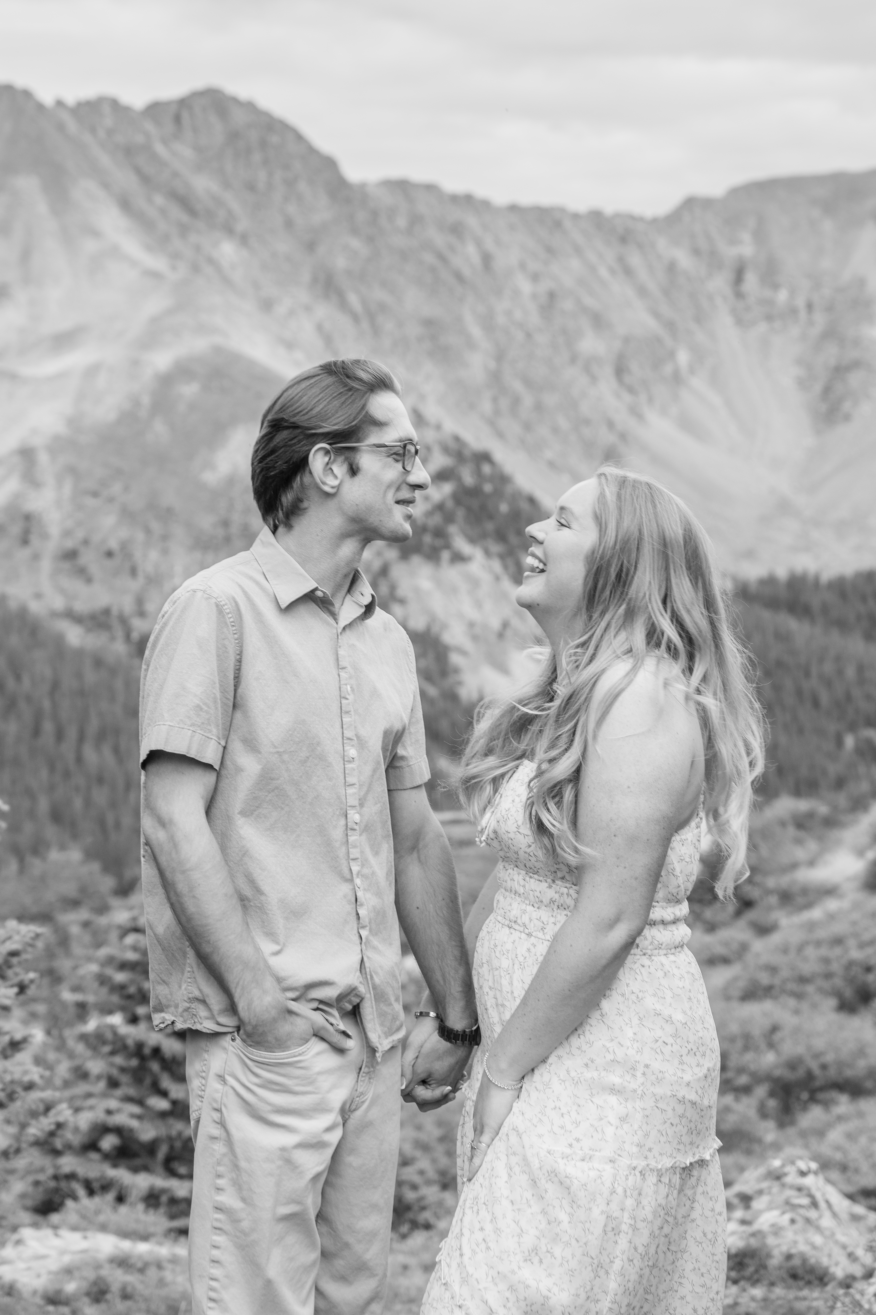 Jerome and Reese laughing together in front of a mountain lake