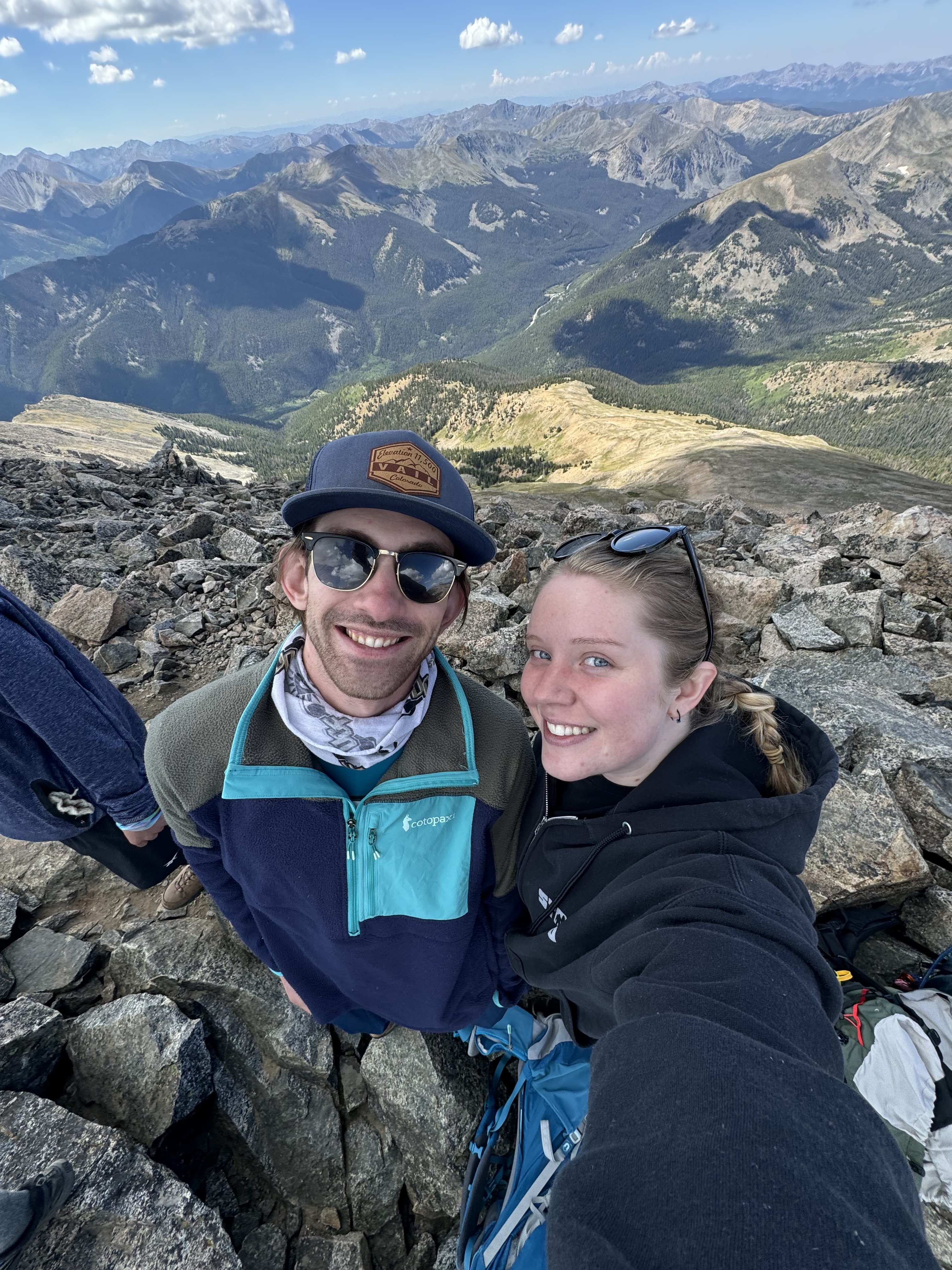 Jerome and Reese smiling together on a Colorado mountain summit